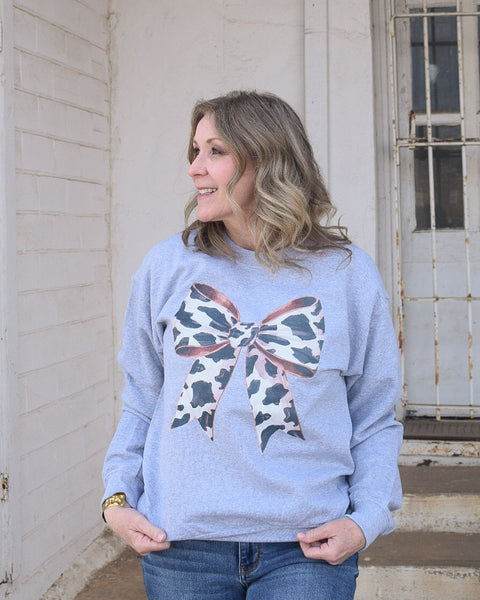 BIG ON BOWS COW PRINT SWEATSHIRT - REG/CURVY - Salty Lime Boutique