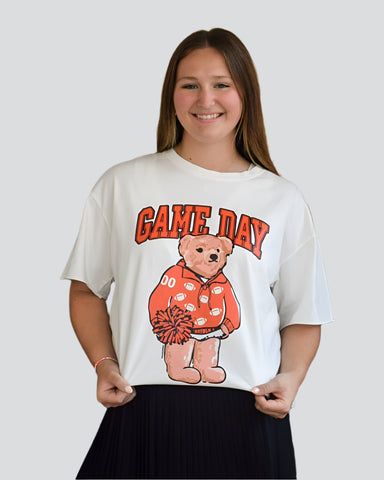 white t-shirt with a bear graphic and 'Game Day' text on a plain background