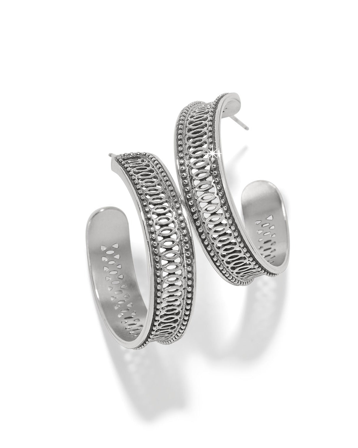 Silver hoop earrings with intricate designs on a white background