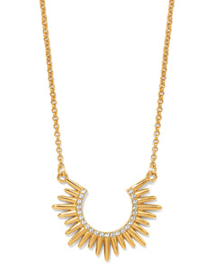 Gold necklace with a sunburst design on a white background